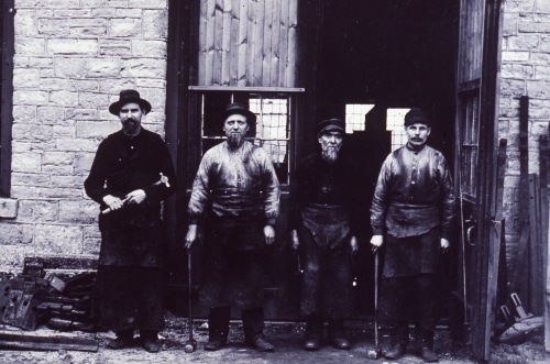 four men in front of Michigan Central Railroad Repair Shops