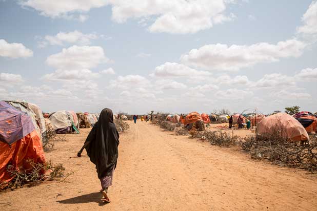 Woman walking through Somalian displacement settlement